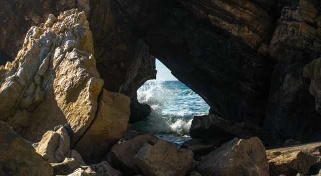 Waves crashing - view through a rock