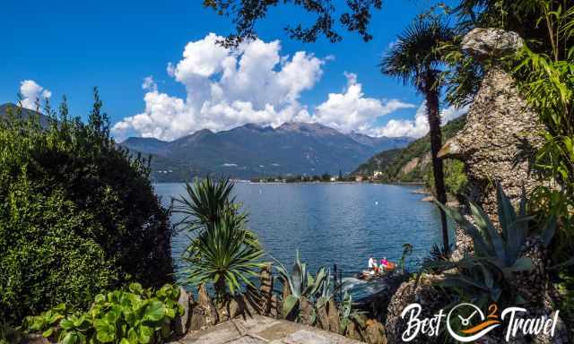 A boat with tourists and mountains in the back 