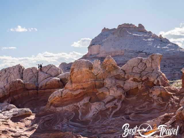 A couple posing on white and orange sandstones