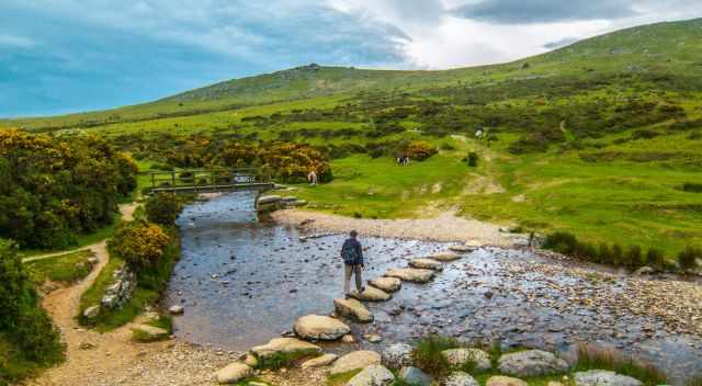 A hiker at the river crossing to get to Widgery Cross